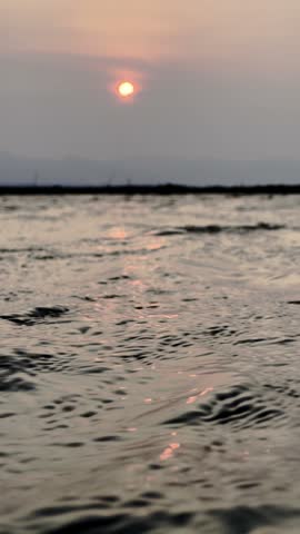 Sunset Over Rippling Lake Water