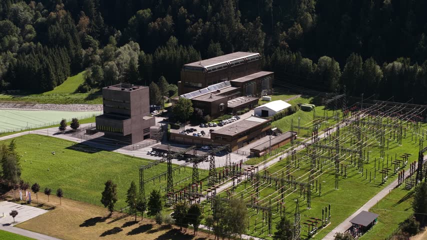 Aerial view of a hydropower plant in Silz, Austria, generating renewable electricity from flowing water and showcasing sustainable energy infrastructure in the Alps.
