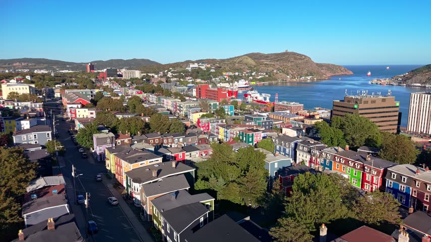 Aerial view of colorful row houses and harbor in downtown St John