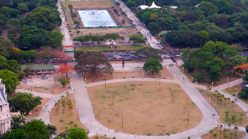 Scenic aerial pan Rizal Luneta Park with water fountains during evening light in Ermita, Manila Philippines