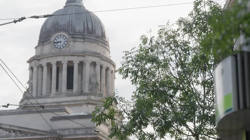 Neoclassical Council House dome above trees in Nottingham, England.