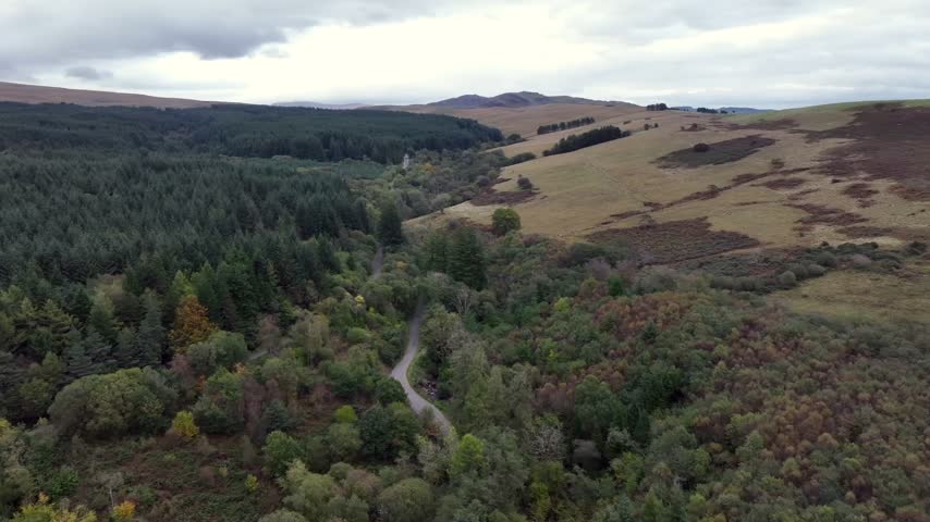Aerial view of a road through the forest at Cwmgiedd leading towards The Sleeping Giant in the Brecon Beacons