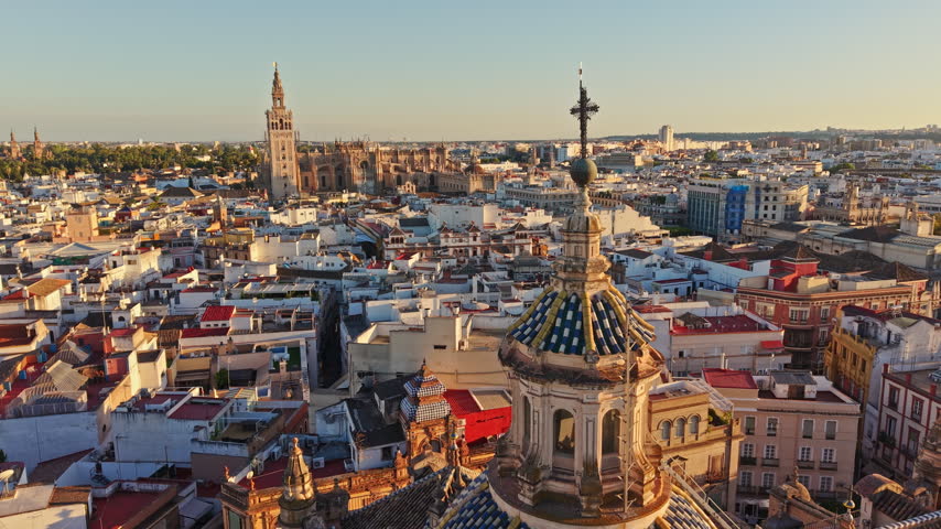 Drone view over the old town of Seville with the Giralda and the cathedral catching the sun, Spain.