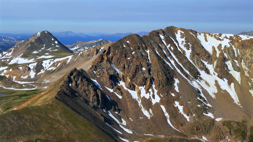 Landscape view of Missouri Mountain Spring Rocky Mountains Collegiate Peaks from Mt Belford Oxford Colorado Missouri Gulch trail Elkhead Pass Sawatch Range alpine tundra snow morning blue sky pan left