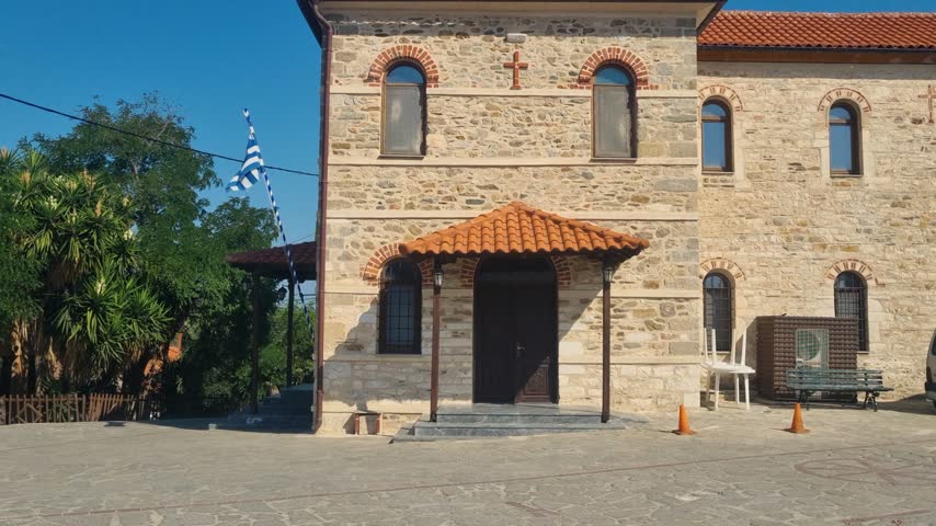 Sunny view of the historic Church of Saint Nicholas, Agios Nikolaos, on Ammouliani Island, Greece, a traditional single nave stone church in the scenic Chalkidiki region