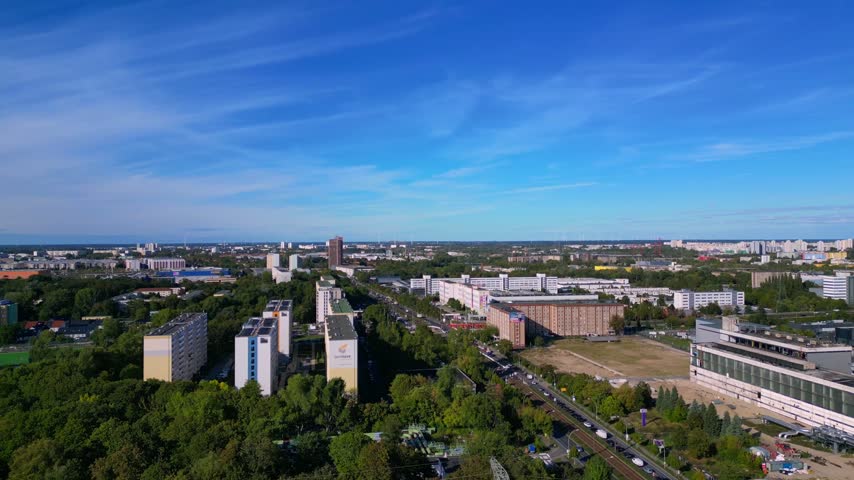 new and old Marzahn power plant showing industrial architecture, development, and energy production against a cityscape background. Unique aerial view drone panorama pan right