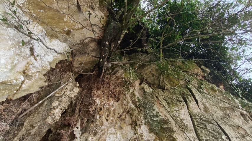 open mountain top cliff going into cave using tunnel