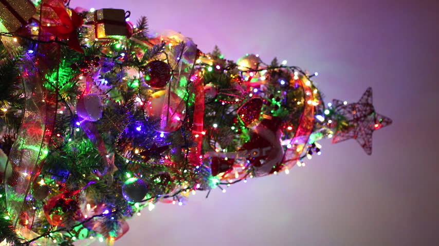 Decorated Christmas tree with fairy lights and hanging ornaments
