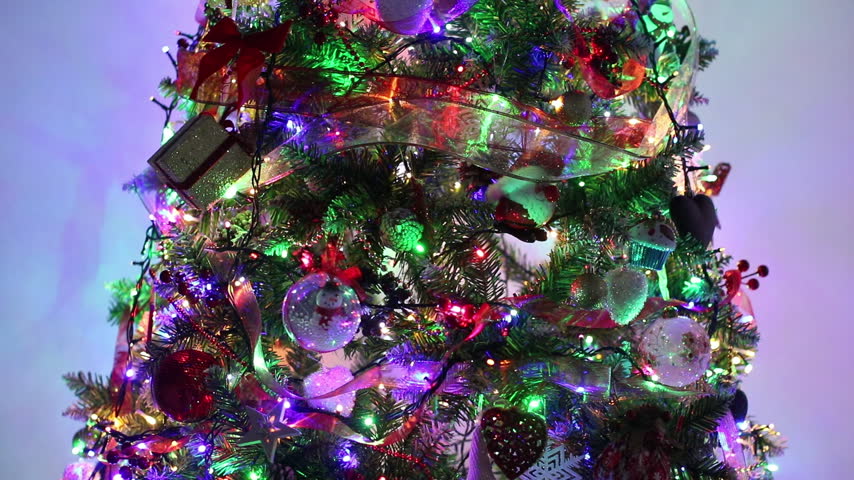 Decorated Christmas tree with fairy lights and hanging ornaments