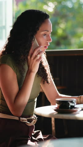 Phone call, laptop and woman in cafe for remote work, ad feedback and brand sponsorship negotiation. Computer, freelancer and person talk to contact, campaign request and social media marketing
