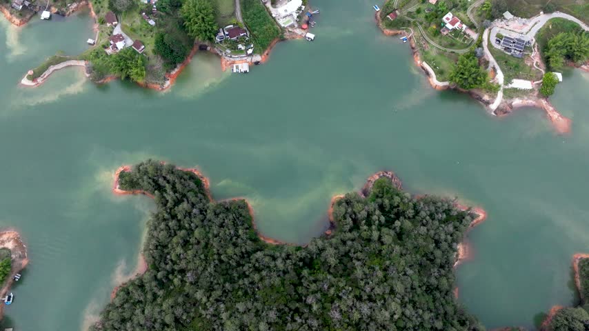 Guatapé Tourism Landscape with Piedra del Peñol, Reservoir and Scenic Islands in Antioquia, Colombia. Establishing Shot. Aerial View.