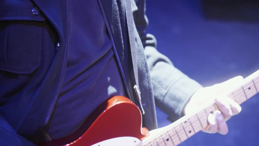 Guitarist Playing Electric Guitar in concert