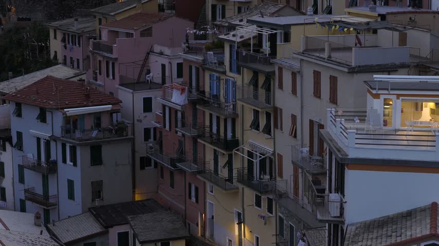 Aerial view of colorful houses and narrow streets in the historic village of Manarola, Liguria, Italy.