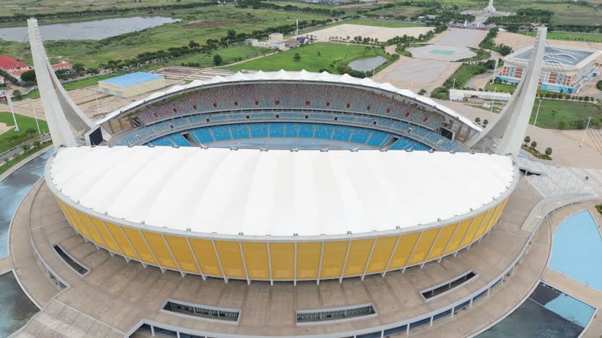 Aerial view of Morodok Techo National Stadium with its distinctive sail-like structures and blue seating in Phnom Penh, Kandal Province, Cambodia.