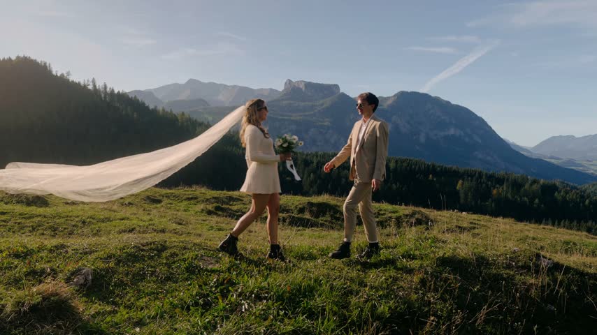 Bride and groom kissing in the mountains