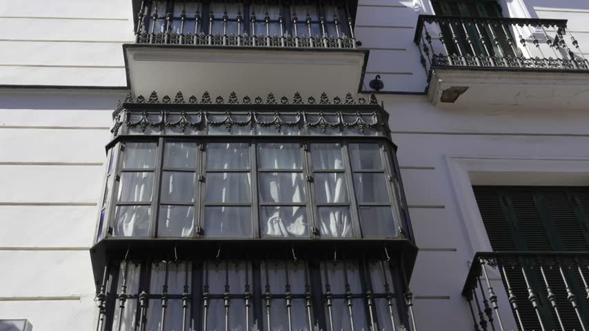 Typical traditional balcony of a residential house in Seville, Andalusia, Spain