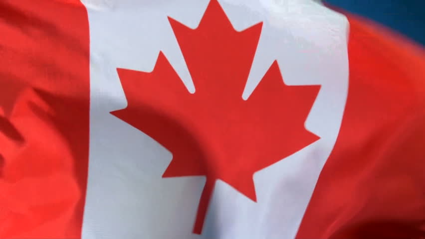 Canadian flag waving in breeze