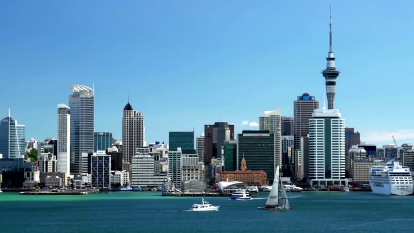 4K Aerial View of Auckland City Skyline Under Clear Blue Sky, North Island New Zealand