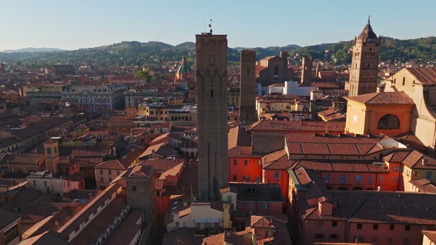 Aerial drone view of Torre Prendiparte, also known as Torre Coronata, in Bologna, Italy, showcasing the medieval tower, terracotta rooftops, and historic old town.
