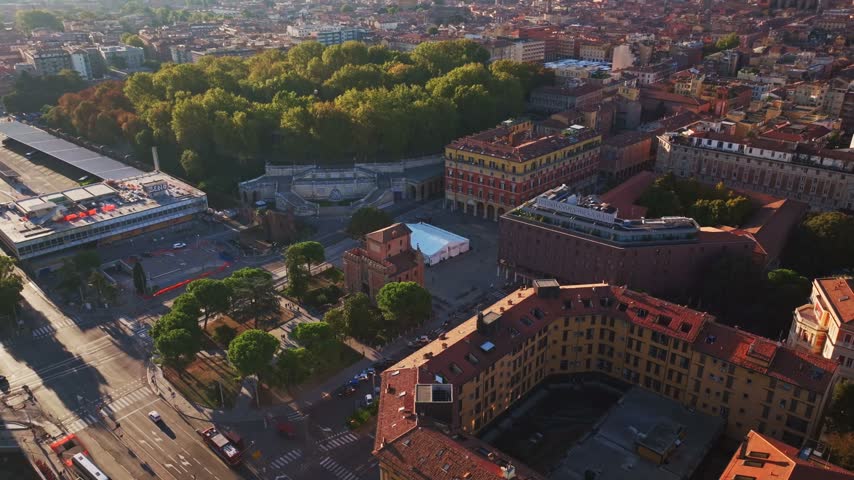 Aerial drone view of Porta Galliera in Bologna, Italy, showcasing the historic medieval city gate, surrounding streets, green spaces, and urban architecture.