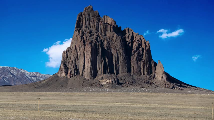 Shiprock, the great volcanic rock mountain in the desert plane of New Mexico, USA.Shiprock, the great volcanic rock mountain in desert plane of New Mexico, USAEstablishing shot of mountains with red rocks background in Slickrock Divide, Capitol Reef National Park, Utah, North America. Day time on . ProRes 422 HQ.Shiprock New Mexico Southwestern Desert Landscape, America, USA.