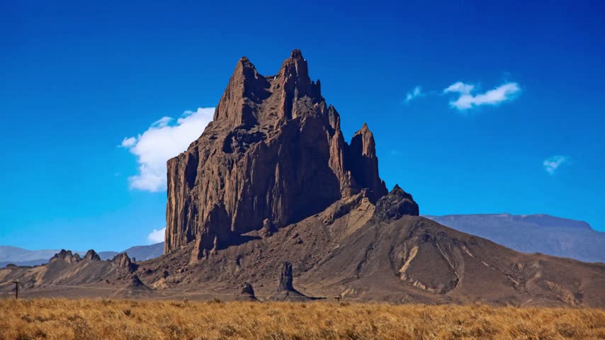 Shiprock, the great volcanic rock mountain in the desert plane of New Mexico, USA.Shiprock, the great volcanic rock mountain in desert plane of New Mexico, USAEstablishing shot of mountains with red rocks background in Slickrock Divide, Capitol Reef National Park, Utah, North America. Day time on . ProRes 422 HQ.Shiprock New Mexico Southwestern Desert Landscape, America, USA.