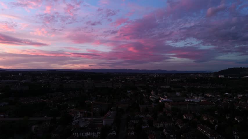 Fly backwards, view of Bern during colorful sunset, Switzerland