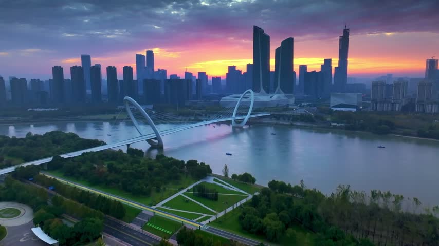 Aerial footage of Nanjing, China, captured in stunning 4K. From the iconic Zifeng Tower piercing the skyline to the serene waters of Xuanwu Lake, this collection showcases the harmonious blend of ancient heritage and modern development. Discover the Ming City Wall, Jiming Temple, and the winding Qinhuai River alongside gleaming skyscrapers and lush green parks. Perfect for travel documentaries, city promotional videos, cultural projects, and establishing shots. 
