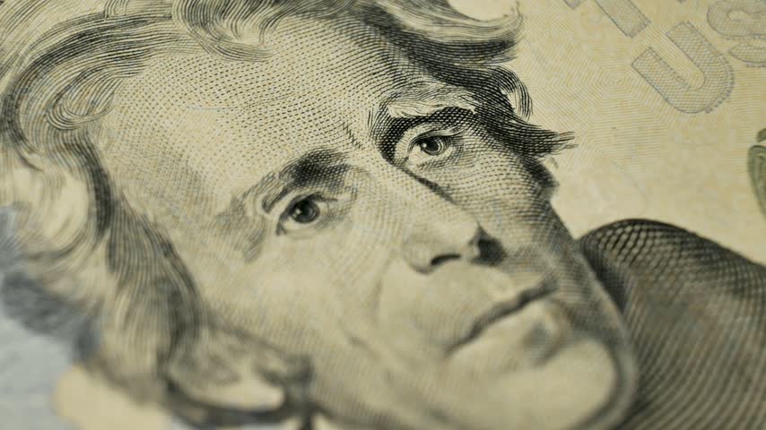 Close up of multiple 20 dollar bills lying in a stack with Andrew Jackson portrait. Bank-issued money circulating as part of financial system ensuring economic stability