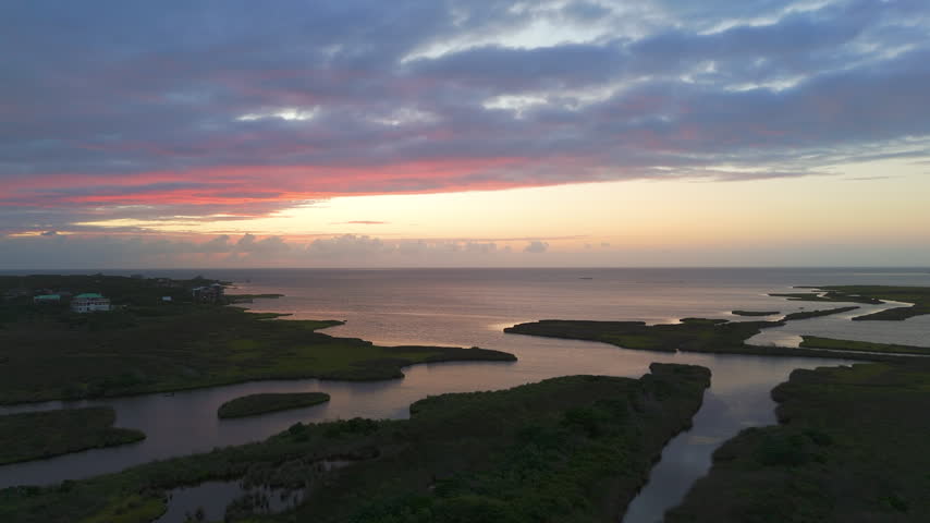 Coastal Wetlands With Marsh Vegetation And Low-lying Terrain Across The Barrier Islands Of The Outer Banks In North Carolina, USA. Aerial Shot