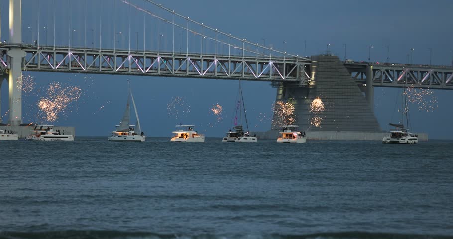 Gwangan Bridge (Gwangandaegyo), Diamond Bridge, Busan, South Korea, illuminated bridge at night in Gwangalli, Suyeong-gu, with fireworks launched from a yachts and boats, seen from Gwangalli Beach