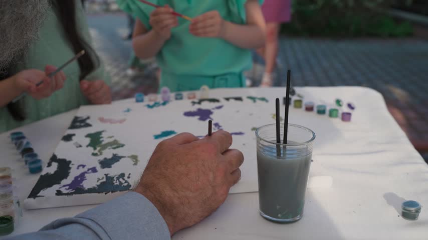 An artist paints a picture on canvas
