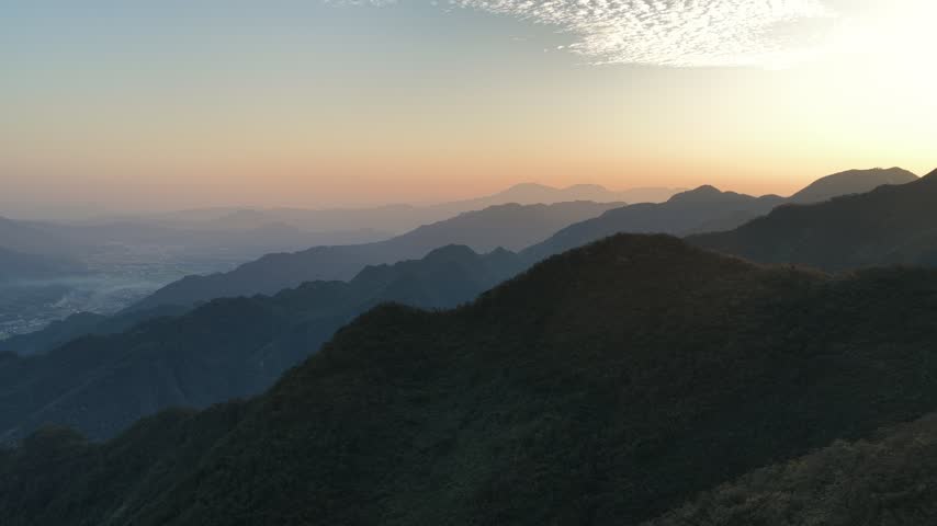 Continuous mountain ranges and layered peaks in the morning light