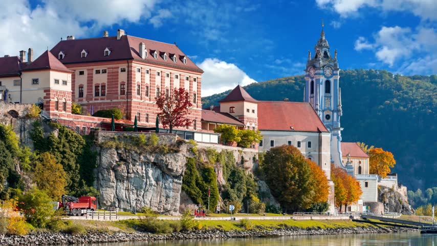 The medieval town of Durnstein along the Danube River in the picturesque Wachau Valley, a UNESCO World Heritage Site, in Lower AustriaDURNSTEIN, AUSTRIA -25 JULY 2015- The medieval town of Durnstein along the Danube River in the picturesque Wachau Valley, a UNESCO World Heritage Site, in Lower Austria.Timelapse of golden autumn in famous tourist landmark town Bad Tolz. Landscape view of Isar river, trees, town bridge, idyllic Bavarian houses and Church. Bad Toelz, Bavaria, Germany.