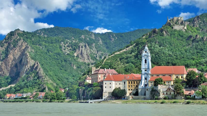 The medieval town of Durnstein along the Danube River in the picturesque Wachau Valley, a UNESCO World Heritage Site, in Lower AustriaDURNSTEIN, AUSTRIA -25 JULY 2015- The medieval town of Durnstein along the Danube River in the picturesque Wachau Valley, a UNESCO World Heritage Site, in Lower Austria.Timelapse of golden autumn in famous tourist landmark town Bad Tolz. Landscape view of Isar river, trees, town bridge, idyllic Bavarian houses and Church. Bad Toelz, Bavaria, Germany.