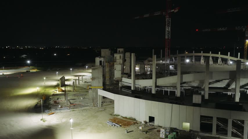 Stadium under construction at night in Venice, Italy showing the developing stadium structure and illuminated construction site