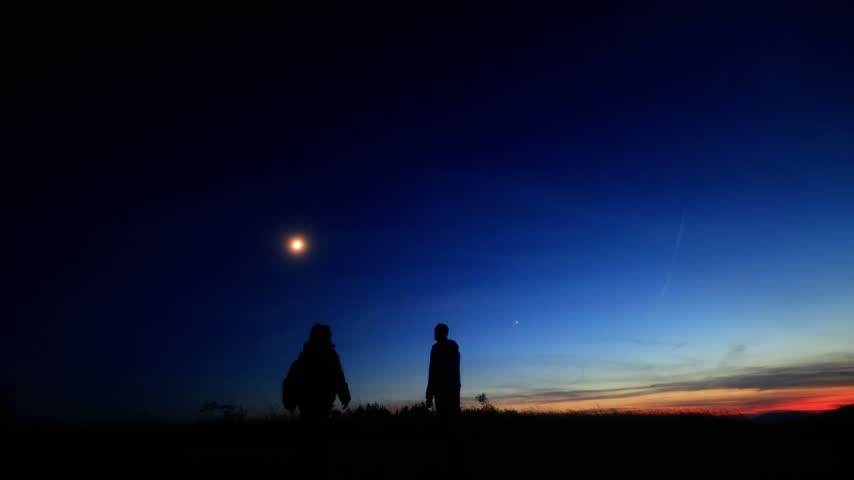Amateur astronomers enjoying night sky with stars, planets, Moon eclipse and other celestial objects.
