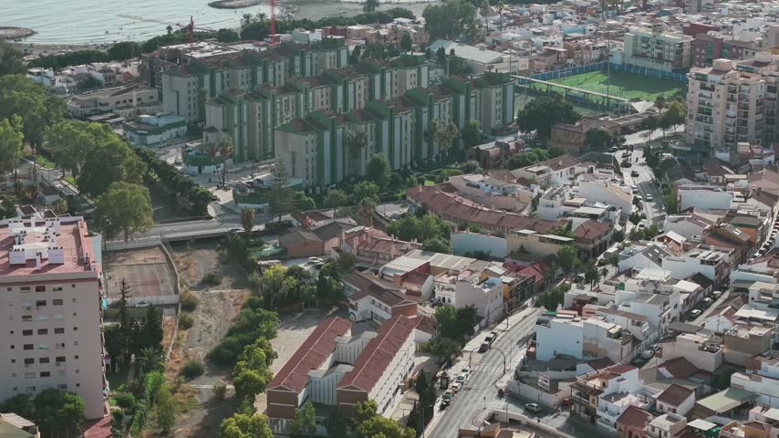 Malaga coastal cityscape with apartments, roads, and the sea from above.