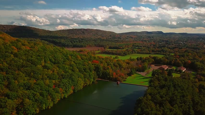 Vibrant fall foliage at Giuffrida Park in Meriden Connecticut with a top hiking trail overview of the lake and forest