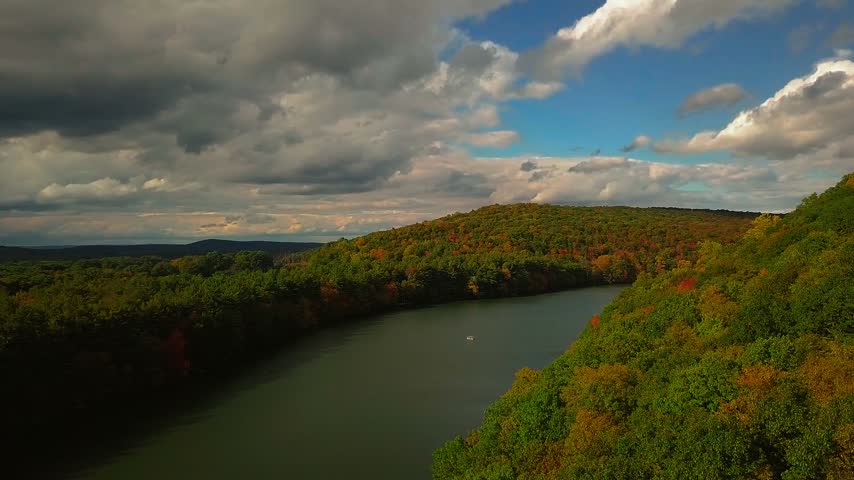 Camera pans left across Giuffrida Park in Meriden Connecticut revealing fall foliage from the top hiking trail