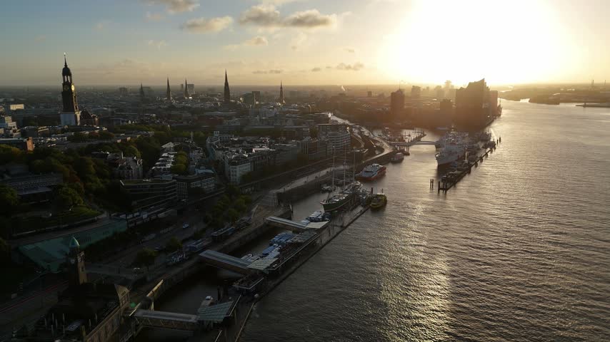 Aerial view of Landungsbrucken and the Elbe river with historic buildings and ships at sunset in Hamburg, Hamburg, Germany.