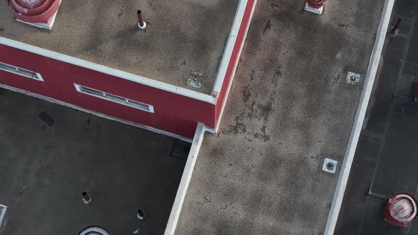 Aerial view of a flat roof building with red metal siding and industrial vents in Hamilton, Ohio, United States.