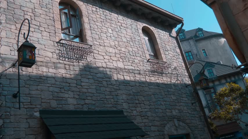 A street view of medieval gothic-style architecture of the French Village with stone walls and classic European buildings. Shot in motion