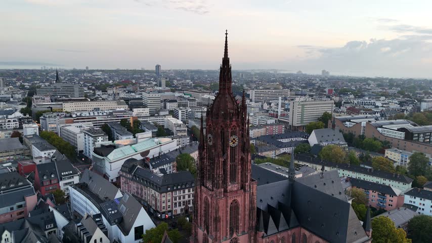Aerial view of the historic Frankfurt Cathedral with its iconic red sandstone tower rising above the urban skyline of Frankfurt am Main, Hessen, Germany.