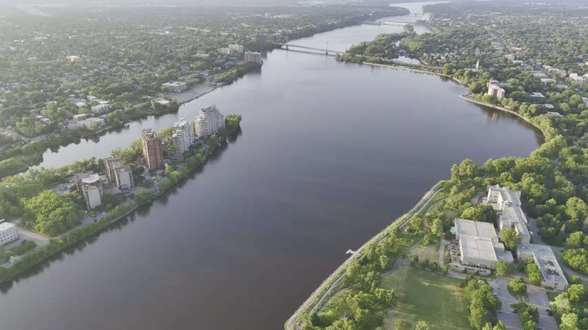 Aerial panoramic view of the Riviere des Prairies between Montreal and Laval, Quebec, Canada at sunset. g.