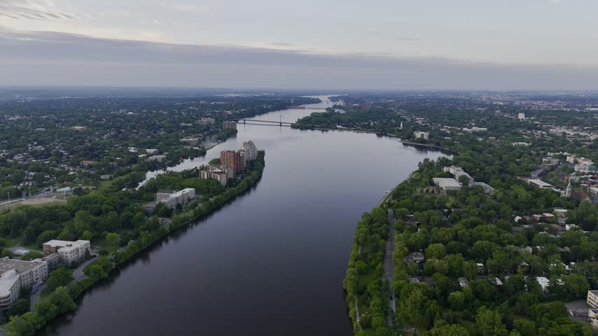 Aerial panoramic view of the Riviere des Prairies between Montreal and Laval, Quebec, Canada at sunset. g.