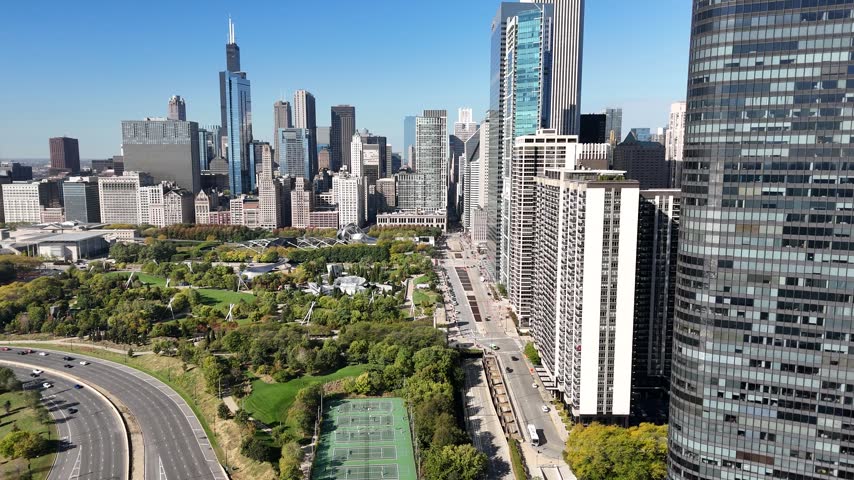 Aerial view of sailboats moored in a Chicago lakefront harbor with skyline. Filmed in Chicago, Illinois.
