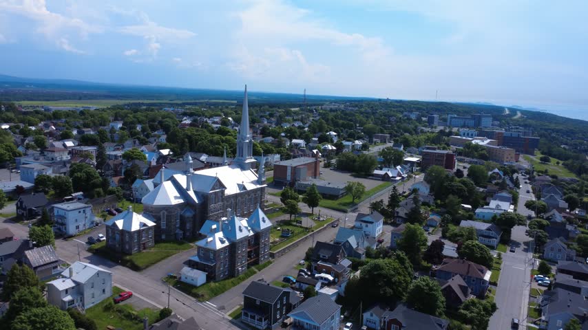 Aerial footage captures the former Saint-François-Xavier Catholic Church, an eclectic-style heritage building dating from 1905 in Rivière-du-Loup, Quebec, Canada.