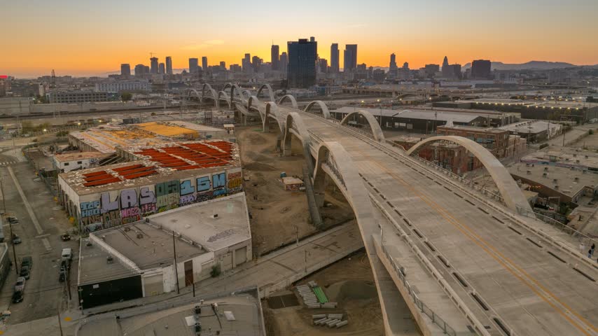 Sunset time-lapse over the Sixth Street Viaduct, rail yards and downtown Los Angeles skyline