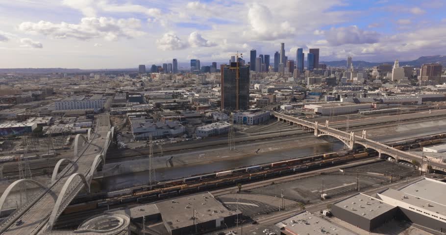 Aerial view of rail yards and the Sixth Street Viaduct toward downtown Los Angeles on a cloudy day